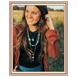 Woman with long hair and layered necklaces standing in a field | Texanna Belles Jewelry