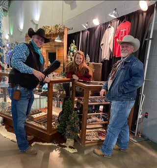 Three people in cowboy attire standing in a store with various items on display | Texanna Belles Jewelry